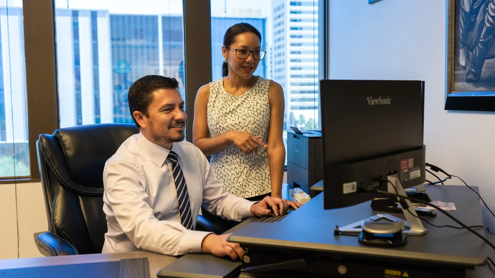 Garcia & Garcia attorneys reviewing work together at a desk
